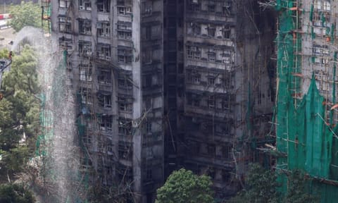 A firefighter works in front of the multiple charred buildings of Wang Fuk Court complex in Tai Po, Hong Kong, on November 28. Reuters
