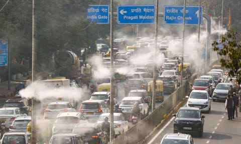 Commuters make their way as water droplets are sprayed through the new mist spray system, installed to curb air pollution, in New Delhi, Thursday, Dec. 4, 2025. (PTI)