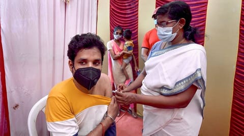 A health worker gives a Covid jab to a person
