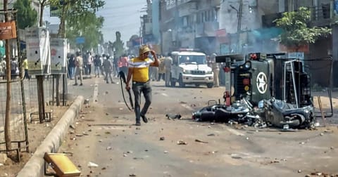 A burnt vehicle in Gujarat's Himmatnagar city following communal clashes.