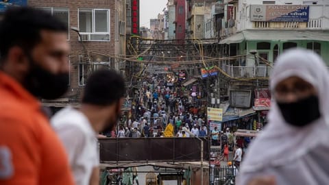People are seen in a crowded marketplace amidst the spread of the coronavirus disease