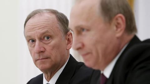 Russian Security Council Secretary Nikolai Patrushev (L) looks at President Vladimir Putin during a meeting with the BRICS countries' senior officials in charge of security matters at the Kremlin in Moscow