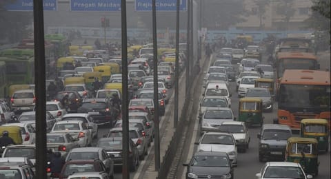 Vehicles in traffic on a road in New Delhi