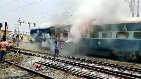 Protestors set a train ablaze during a protest against Agnipath scheme