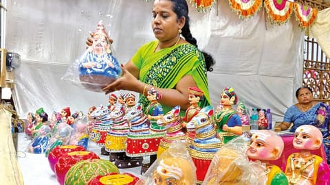 Women SHG member displaying dolls