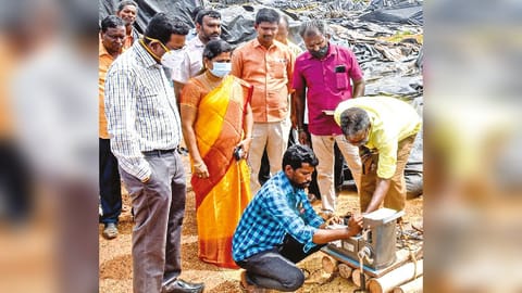 Thanjavur Collector Dinesh Ponraj Oliver inspecting paddy damaged at open DPC at Munnayampatti on Monday