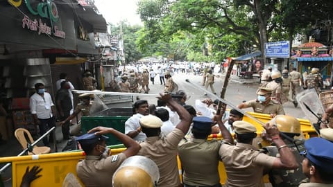 Cops chasing protesters who vandalised properties.
