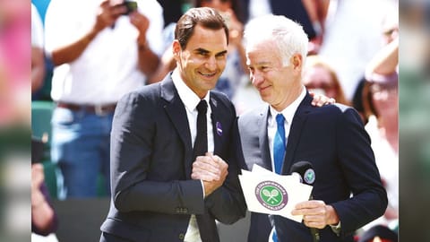 Former winners of Wimbledon, Roger Federer and John McEnroe take part in the Centre Court Centenary Ceremony