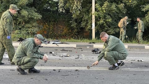 Investigators work on the site of explosion