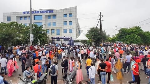 Students gather outside an exam centre after the NTA cancelled second shift of the CUET UG 2022.