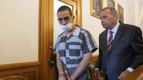 Hadi Matar, 24, left, and defense attorney Nathaniel Barone, right, talk after an arraignment in the Chautauqua County Courthouse in Mayville.