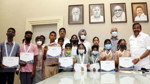 State Municipal Administration  Minister KN Nehru handing over certificates to Chennai Corporation school students