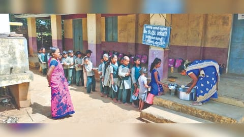 Tribal children queue up to get their breakfast at a school in Jawadhu Hills on Friday.