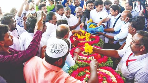 Ministers KN Nehru, KS Masthan and Mahesh Poyyamozhi paying tribute to Muthukumaran at Tiruchy airport on Friday.