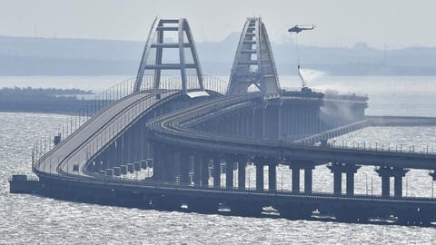 A helicopter drops water to stop fire on the Crimean Bridge
