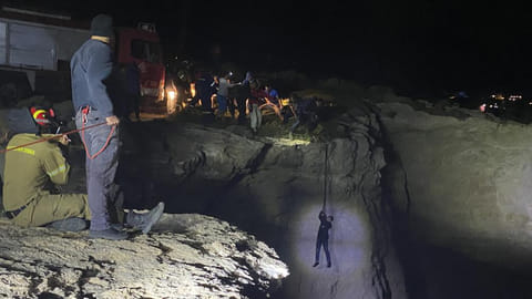 Authorities and local residents save a migrant during a large-scale rescue operation