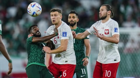 Saudi Arabia's Nawaf Al-Abed, left, and Poland's Krystian Bielik, center, fight for the ball during the World Cup group C soccer match between Poland and Saudi Arabia, at the Education City Stadium in Al Rayyan, Qatar, Saturday.