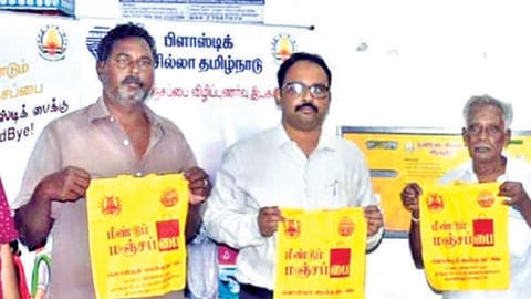 Tiruvallur Collector Dr Alby John Varghese with manjapai dispensed by the new machine.