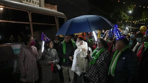 People carry the statue of baby Jesus