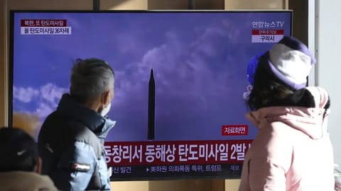 People watch a TV screen showing a news program about North Korea's missile launch with file footage, at the Seoul Railway Station in Seoul, South Korea, Sunday.