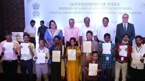 Ma Subramanian providing offer letter to candidates at job fair organised exclusively for rainee placement of persons with disabilities.
