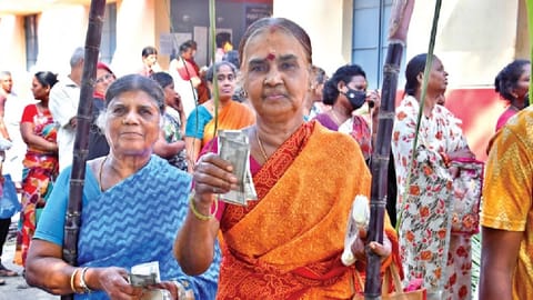 People coming out of PDS shop after collecting the Pongal gift hamper in Chennai on Monday.