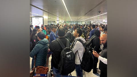Passengers wait at IGI Airport as flights delayed.