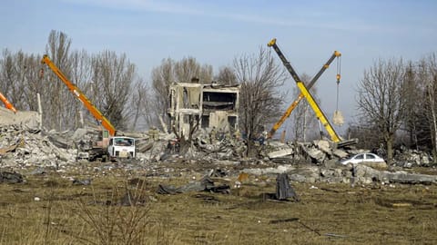 Workers clean rubbles after Ukrainian rocket strike in Makiivka, in Russian-controlled Donetsk region, eastern Ukraine.