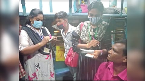 A ticket checking squad booking a violator on a train in Salem division