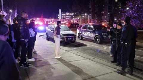 Students get directions from police on the campus of Michigan State University