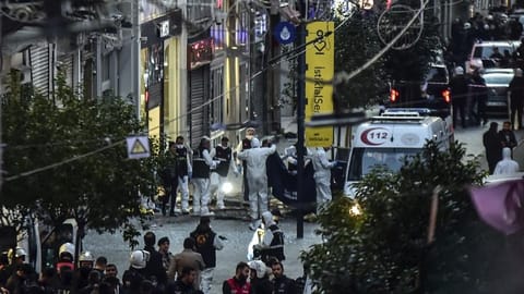 Forensic experts collect a dead body after an explosion on Istanbul's popular pedestrian Istiklal Avenue