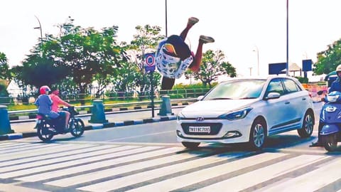 A youth showing off his gymnastic skills on Kamarajar Salai near Marina beach