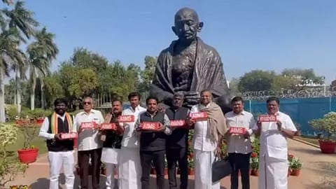 Tamil Nadu MP's holding bricks that read 'AIIMS'