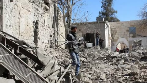 People inspect the damage at the Citadel of Damascus, in the aftermath of what state media said were Israeli air strikes, Syria