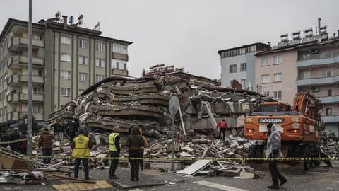 Emergency teams search for people in the rubble of a destroyed building in Gaziantep, Turkey.