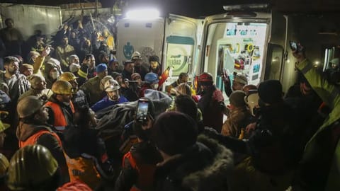 Rescue workers pull out a young woman from a collapsed building in Adiyaman, southern Turkey.