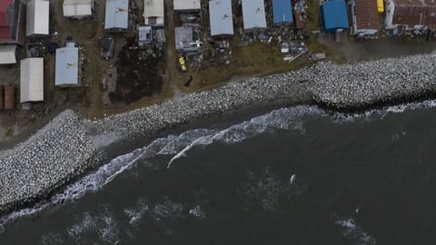 Small waves crash into reinforced seawalls in Shishmaref