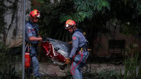 Firefighters carry parts of a helicopter after it crashed in Sao Paulo, killing 4 people according to the authorities, in Sao Paulo, Brazil
