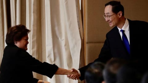 Department of Foreign Affairs Theresa Lazaro shakes hands with China's Vice Foreign Minister Sun Weidong