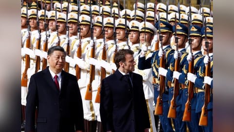 Chinese President Xi Jinping and French President Emmanuel Macron review troops