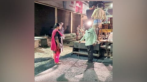 Officials inspecting road laying work