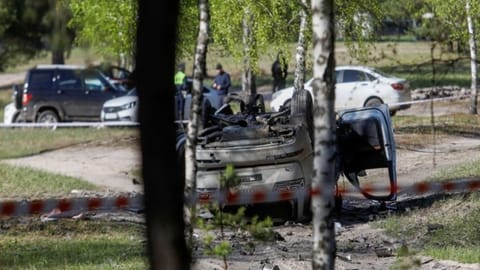 Damaged car lying overturned on track next to wood after Zakhar Prilepin was injured.