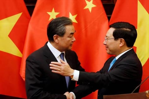 China's Foreign Minister Wang Yi (L) with Vietnam's Deputy PM and Foreign Minister Pham Binh Minh