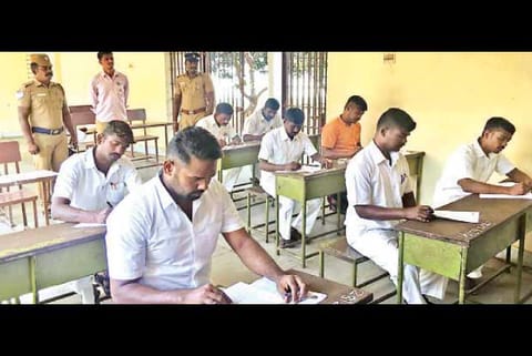 Image of prison inmates writing exam used for representative purpose