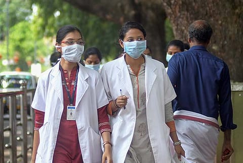 Doctors wear safety masks as a precaution after the outbreak of Nipah virus in Kozhikode