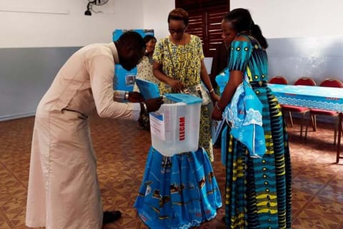 Electoral workers prepare the polling station where President Paul Biya will cast his ballot