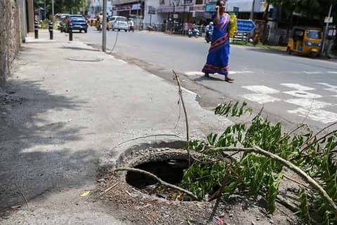 The manhole is filled with sewage and also damaged in such a way that it would clog free flow of rainwater
