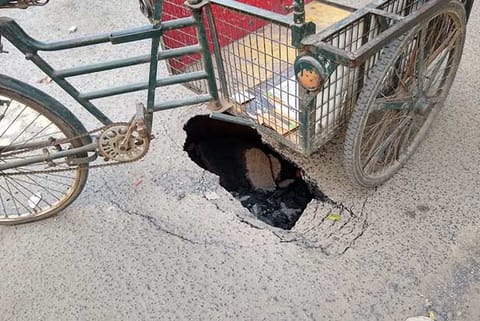 Road cave in was covered by a tricycle to alert the approaching vehicles