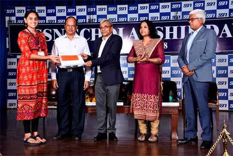 A student receives scholarship on the 20th Annual Scholarship Day
