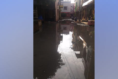 Sewage water from the stormwater drain enters the streets of the housing board